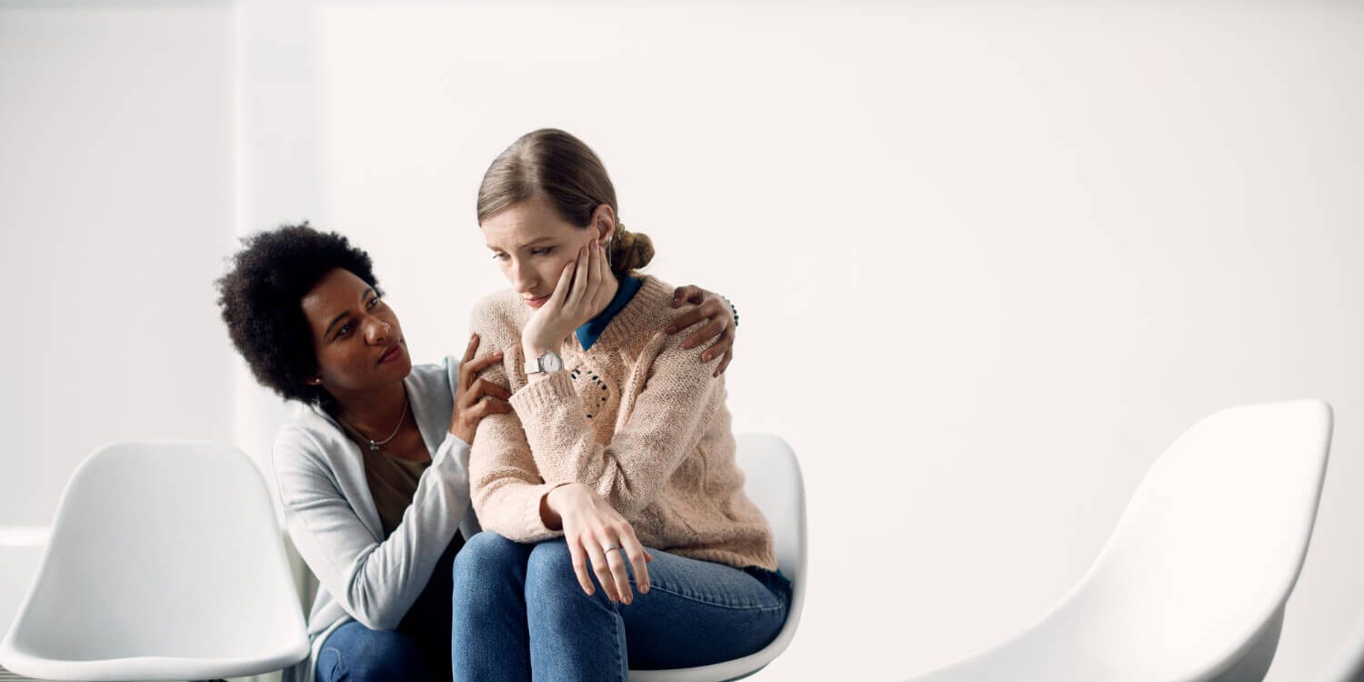 caring-african-american-woman-consoling-sad-woman-before-group-therapy-meeting-1 drug rehab that accepts medicaid