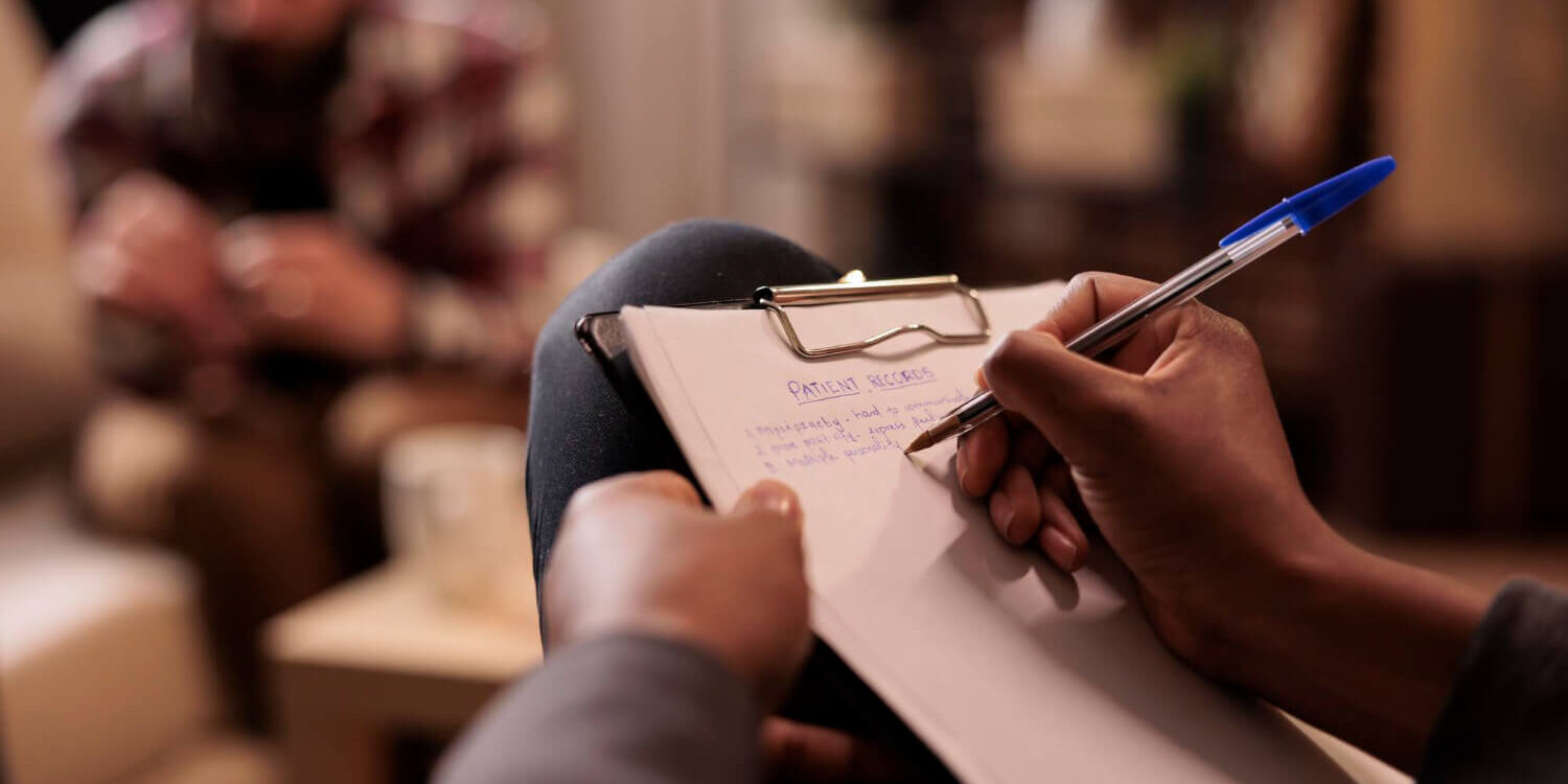 male-psychologist-taking-notes-couple-therapy-session-help-with-relationship-issues-counselor-giving-advice-explaining-marriage-problems-using-paper-psychoanalysis-close-up-1 inpatient drug rehab clinic