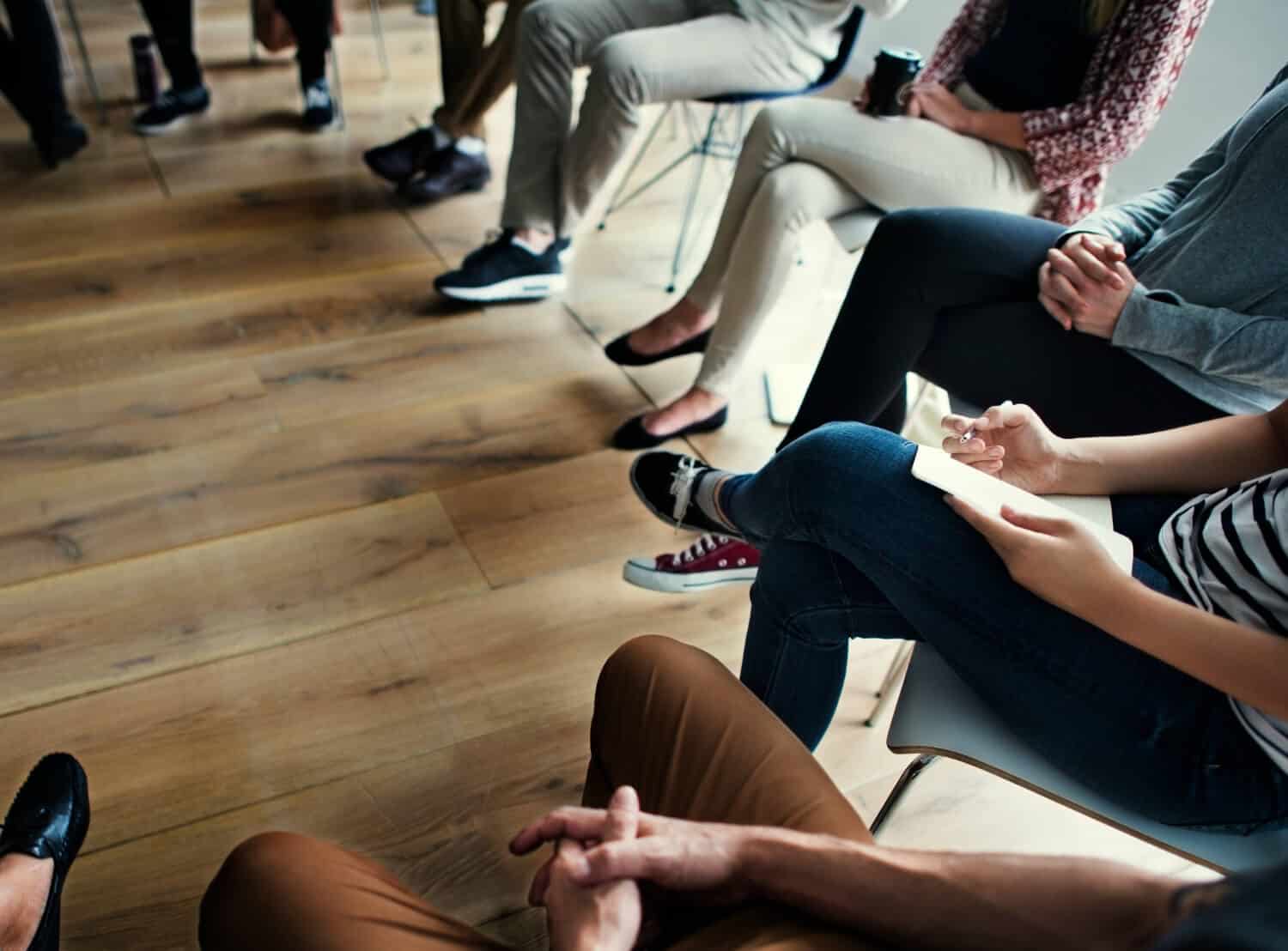people-meeting-seminar-office-concept-3-1 People sitting together for a group nicotine addiction treatment therapy.